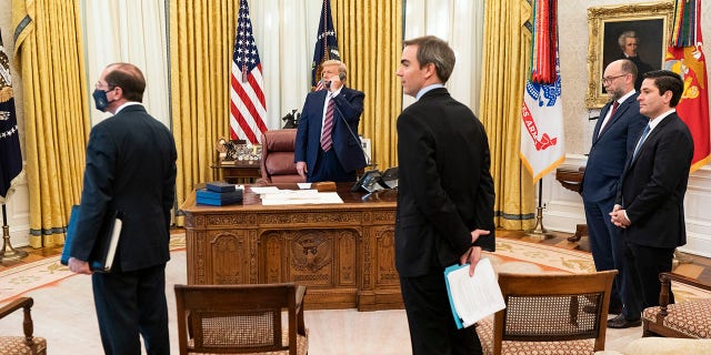 President Donald J. Trump talks on the phone on Friday, Nov. 20, 2020, in the Oval Office of the White House. Brian Morgenstern is at far right.