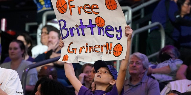 A young Phoenix Mercury fan holds up a sign "Free Brittney Griner" during a WNBA basketball game against the Las Vegas Aces, Friday, May 6, 2022, in Phoenix.