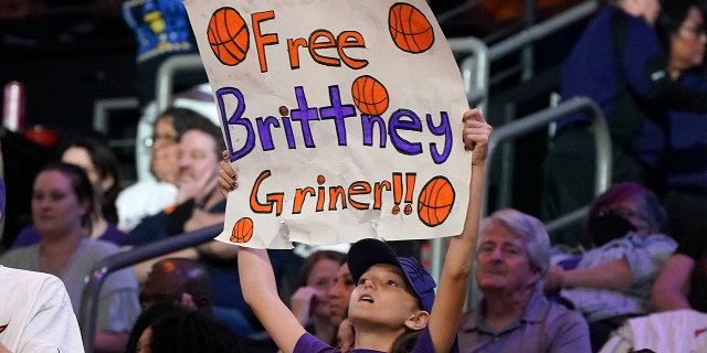 A young Phoenix Mercury fan holds up a sign "Free Brittney Griner" during a WNBA basketball game against the Las Vegas Aces, Friday, May 6, 2022, in Phoenix.