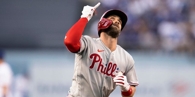 Philadelphia Phillies' Bryce Harper celebrates his solo home run against the Los Angeles Dodgers during the first inning of a baseball game in Los Angeles, Thursday, May 12, 2022. 