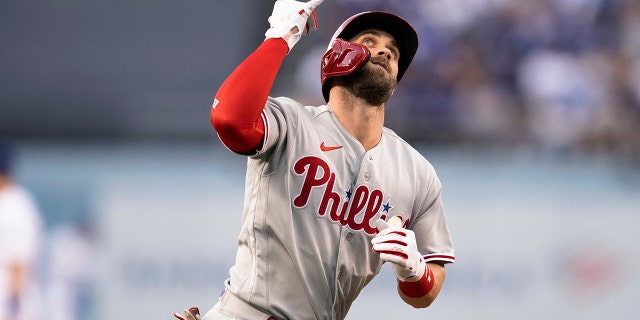 Philadelphia Phillies' Bryce Harper celebrates his solo home run against the Los Angeles Dodgers during the first inning of a baseball game in Los Angeles, Thursday, May 12, 2022.