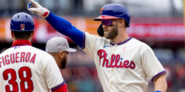 Bryce Harper (3) of the Philadelphia Phillies gestures from first base after hitting an RBI single during the third inning of the first game of a double header against the New York Mets on Sunday, May 8, 2022, in Philadelphia.