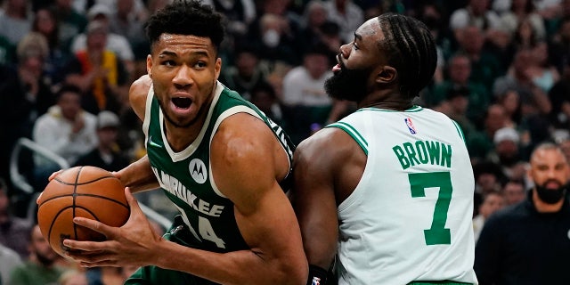 Milwaukee Bucks' Giannis Antetokounmpo is fouled by Boston Celtics' Jaylen Brown during the first half of Game 6 of an NBA basketball Eastern Conference semifinals playoff series Friday, May 13, 2022, in Milwaukee . (AP Photo/Morry Gash)