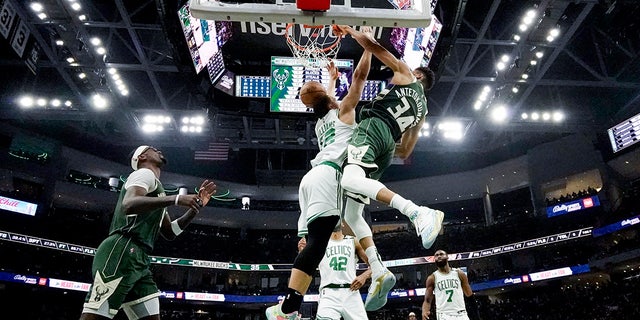 Milwaukee Bucks' Giannis Antetokounmpo dunks over Boston Celtics' Grant Williams during the second half of Game 6 of an NBA basketball Eastern Conference semifinals playoff series Friday, May 13, 2022, in Milwaukee. (WHD Photo/Morry Gash)