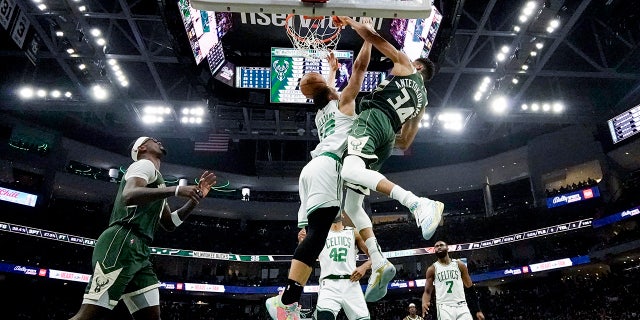 Milwaukee Bucks' Giannis Antetokounmpo dunks over Boston Celtics' Grant Williams during the second half of Game 6 of an NBA basketball Eastern Conference semifinals playoff series Friday, May 13, 2022, in Milwaukee. (AP Photo/Morry Gash)