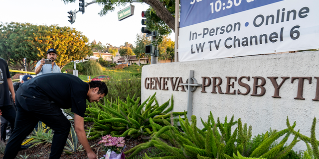 Hector Gomez, left, and Jordi Poblete, worship leaders at the Mariners Church Irvine, leave flowers outside the Geneva Presbyterian Church in Laguna Woods, Calif., Sunday, May 15, 2022, after a fatal shooting. (AP Photo/Damian Dovarganes)