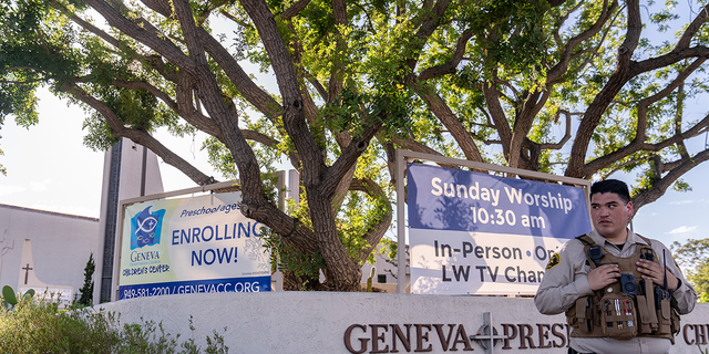 An Orange County Sheriff's Department officer guards the grounds at Geneva Presbyterian Church in Laguna Woods, Calif., Sunday, May 15, 2022, after a fatal shooting. 