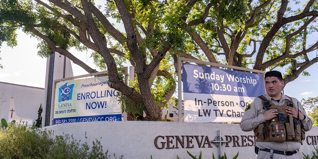 An Orange County Sheriff's Department officer guards the grounds at Geneva Presbyterian Church in Laguna Woods, Calif., Sunday, May 15, 2022, after a fatal shooting.