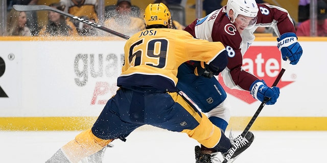 Colorado Avalanche defenseman Cale Makar (8) passes the puck past Nashville Predators' Roman Josi (59) during the first period in Game 4 of an NHL hockey first-round playoff series Monday, May 9, 2022, in Nashville, Tenn. 