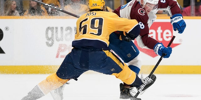 Colorado Avalanche defenseman Cale Makar (8) passes the puck past Nashville Predators' Roman Josi (59) during the first period in Game 4 of an NHL hockey first-round playoff series Monday, May 9, 2022, in Nashville, Tenn.