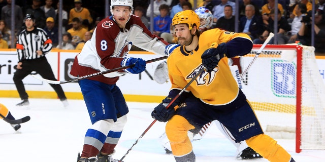 Colorado Avalanche defenseman Cale Makar (8) defends against Nashville Predators left wing Filip Forsberg (9), of Sweden, during Game 4 of the first round of the Stanley Cup Playoffs between the Nashville Predators and Colorado Avalanche, held on May 9, 2022, at Bridgestone Arena in Nashville, Tennessee.