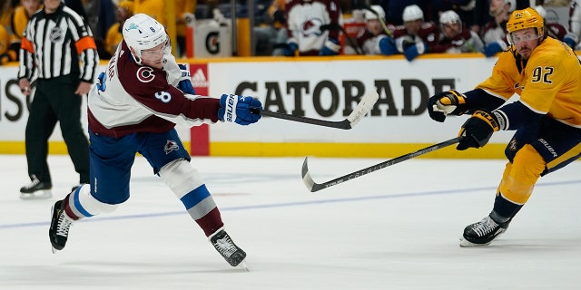 Cale Makar #8 of the Colorado Avalanche takes a shot on goal as Ryan Johansen #92 of the Nashville Predators defends during the second period of Game Four of the First Round of the 2022 Stanley Cup Playoffs at Bridgestone Arena on May 09, 2022 in Nashville, Tennessee.
