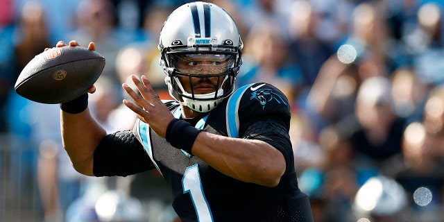Cam Newton of the Panthers looks to pass against the Tampa Bay Buccaneers at Bank of America Stadium on Dec. 26, 2021 in Charlotte, North Carolina.