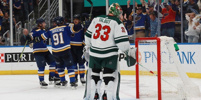 St. Louis Blues celebrate after a goal against Minnesota Wild goalie Cam Talbot during the second period in Game 6 of an NHL hockey Stanley Cup first-round playoff series Thursday, May 12, 2022, in St. Louis.
