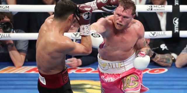 Canelo Álvarez punches Dmitry Bivol during their fight at the T-Mobile Arena on May 7, 2022 in Las Vegas, Nevada.