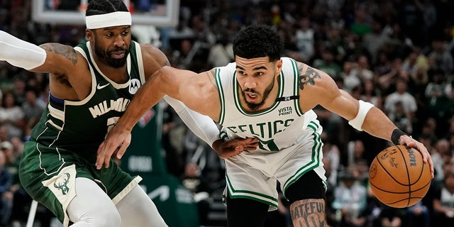 Boston Celtics' Jayson Tatum tries to get past Milwaukee Bucks' Wesley Matthews during the second half of Game 6 of an NBA basketball Eastern Conference semifinals playoff series Friday, May 13, 2022, in Milwaukee.  The Celtics won 108-95 to tie the series at 3-3.  (AP Photo/Morry Gash)