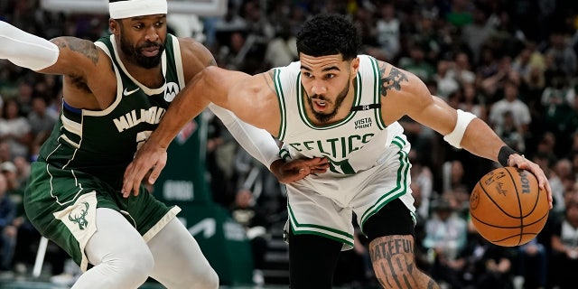Boston Celtics' Jayson Tatum tries to get past Milwaukee Bucks' Wesley Matthews during the second half of Game 6 of an NBA basketball Eastern Conference semifinals playoff series Friday, May 13, 2022, in Milwaukee. The Celtics won 108-95 to tie the series at 3-3. (AP Photo/Morry Gash)
