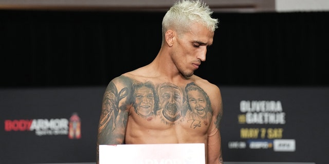 Brazil's Charles Oliveira reacts after failing to gain weight, leaving the UFC lightweight championship during the UFC 274 official weigh-in at the Hyatt Regency hotel on May 6, 2022 in Phoenix, Ariz.