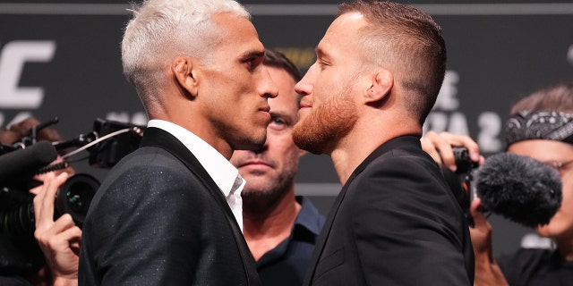 Charles Oliveira of Brazil and Justin Gaethje face off during the UFC 274 press conference at Arizona Federal Theatre May 5, 2022, in Phoenix, Ariz.