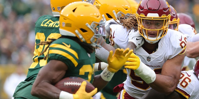 Washington's Chase Young pursues Aaron Jones of the Packers at Lambeau Field on Oct. 24, 2021, in Green Bay, Wisconsin.