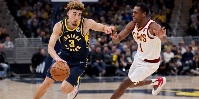 Chris Duarte of the Pacers drives against Rajon Rondo of the Cleveland Cavaliers at Gainbridge Fieldhouse on March 8, 2022, in Indianapolis, Indiana.