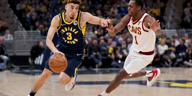 Chris Duarte of the Pacers drives against Rajon Rondo of the Cleveland Cavaliers at Gainbridge Fieldhouse on March 8, 2022, in Indianapolis, Indiana.
