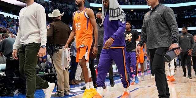 Phoenix Suns forward Mikal Bridges and guard Chris Paul walk off the court after the Mavericks' playoff game, Sunday, May 8, 2022, in Dallas.