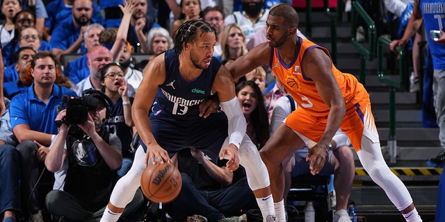 Chris Paul of the Phoenix Sons plays defense against Jalen Brunson of the Mavericks during Game 4 of the 2022 NBA Playoff Western Conference semifinals on May 8, 2022 at the American Airlines Center in Dallas, Texas.