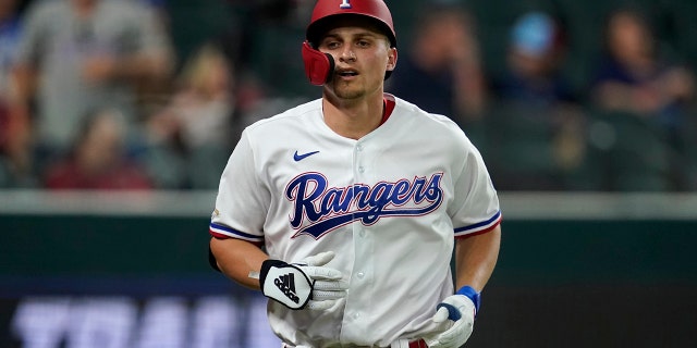 Texas Rangers' Corey Seager jogs to the dugout after hitting a solo home run in the third inning of a baseball game against the Kansas City Royals, Tuesday, May 10, 2022, in Arlington, Texas. 