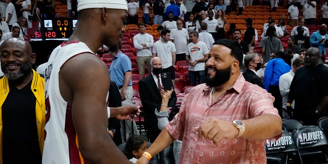 Heat forward Jimmy Butler, is congratulated DJ Khaled after the win over the Philadelphia 76ers, Tuesday, May 10, 2022, in Miami.
