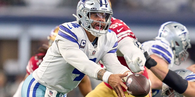 Dallas Cowboys quarterback Dak Prescott handles the football against the San Francisco 49ers on Jan. 16, 2022, in Arlington, Texas.