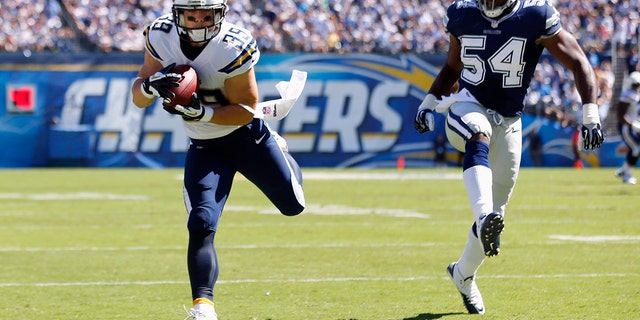 San Diego Chargers Run Danny Woodhead (39) holding a first-half touchdown pass against the Dallas Cowboys outside linebacker Bruce Carter, 54, during their NFL football match in San Diego, California on September 29, 2013.