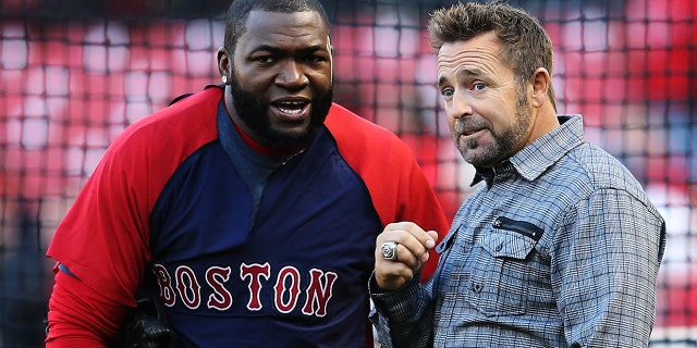 David Ortiz, left, of the Boston Red Sox talks to former Red Sox player Kevin Millar before taking on the St. Louis Cardinals in Game 3 of the 2013 World Series at Busch Stadium Oct. 26, 2013, in St Louis.