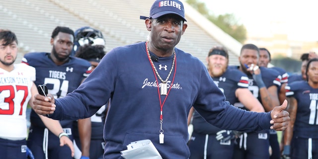 Deion "Prime" Sanders talks with his team after the conclusion of the annual spring football game.