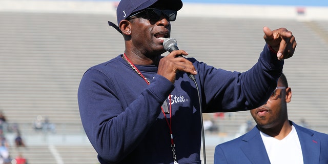 Jackson State football coach Deion "Prime" Sanders talks with fans during the annual spring football game.