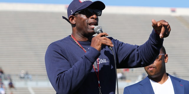 Jackson State football coach Deion "Prime" Sanders talks with fans during the annual spring football game.