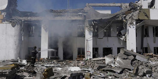 A firefighter works to extinguish a blaze after a Russian airstrike hit the House of Culture, which was used to distribute aid, in Derhachi, Ukraine, on May 13.