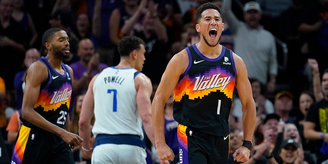 Phoenix Suns guard Devin Booker (1) celebrates a basket against the Dallas Mavericks during the first half of Game 1 in the second round of the NBA Western Conference playoffs May 2, 2022, in Phoenix.