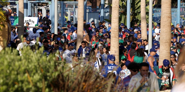 Los Angeles Dodgers fans walk through the gates prior to the second game of a doubleheader against the Arizona Diamondbacks at Dodger Stadium May 17, 2022, a Los Angeles.
