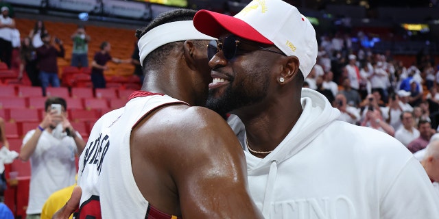 Jimmy Butler #22 of the Miami Heat hugs former Miami Heat player Dwyane Wade after Game Two of the Eastern Conference Semifinals against the Philadelphia 76ers at FTX Arena on May 04, 2022 in Miami, Florida.