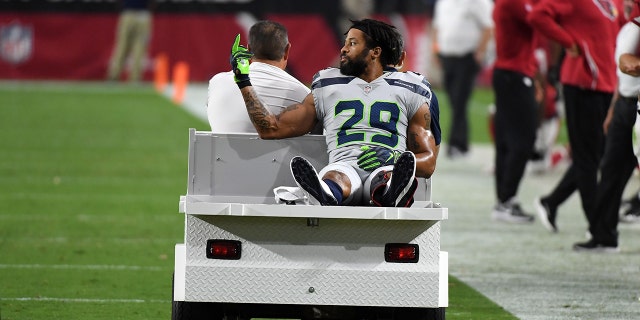 Defensive back Earl Thomas of the Seattle Seahawks gestures as he leaves the field on a cart after being injured during the fourth quarter against the Arizona Cardinals at State Farm Stadium Sept. 30, 2018, in Glendale, Ariz.
