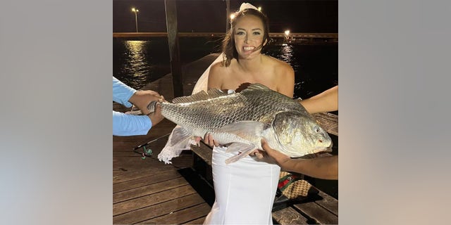 Eliot Granville caught a fish on her wedding night. She estimates it weighed about 50 pounds.