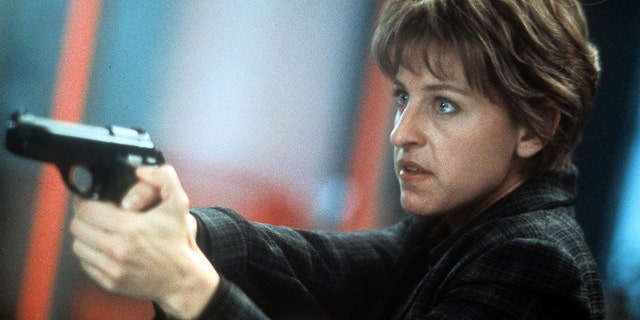 Ellen DeGeneres aiming pistol in a scene from the film 'Goodbye Lover', 1998. (Photo by Warner Brothers/Getty Images)