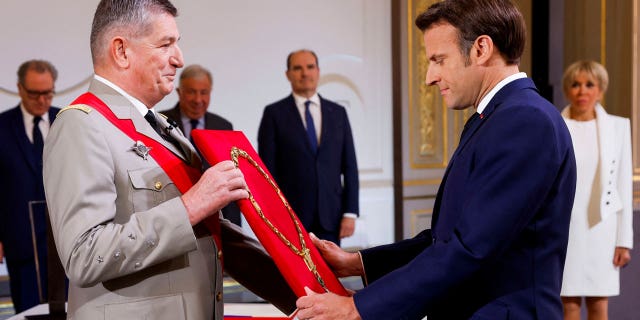 French Presidential Chief of Military Staff Benoit Puga, left, and French President Emmanuel Macron attend Macron's inauguration ceremony for a second term at the Élysée Palace in Paris on Saturday 7 May 2022.