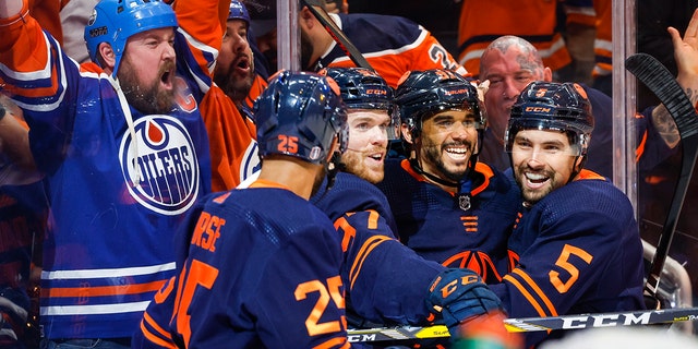 Edmonton Oilers winger Evander Kane, second right, celebrates his goal with teammates during the second period of the NHL Hockey Stanley Cup second round playoff series game on Sunday, May 22, 2022 in Edmonton, Alberta.