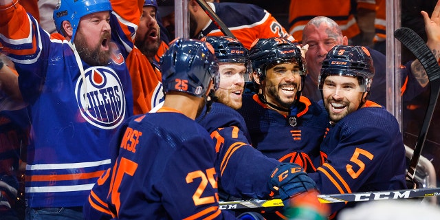 Edmonton Oilers winger Evander Kane, second right, celebrates his goal with teammates during the second period of an NHL hockey Stanley Cup second-round playoff series game in Edmonton, Alberta, Sunday, May 22, 2022.