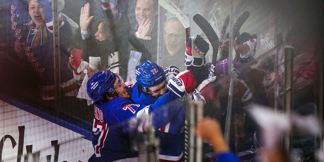 New York Rangers' Frank Vatrano (77) celebrates with Filip Chytil (72) after Chytil scored a goal during the third period of Game 5 of an NHL hockey Stanley Cup first-round playoff series against the Pittsburgh Penguins Wednesday, May 11, 2022, in New York. The Rangers won 5-3.