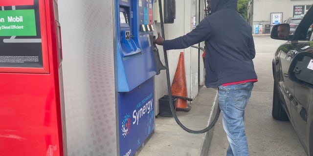 A gas station attendant fills up a customer's tank (Megan Myers/Fox News Digital)