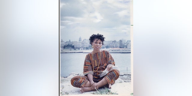 JoAnn Chesimard, aka Assata Shakur, holding the manuscript of her autobiography with Old Havana, Cuba, in the background on October 7, 1987. 