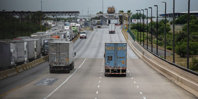 Trucks travel across the World Trade International Bridge in Laredo, Texas, on June 10, 2019.